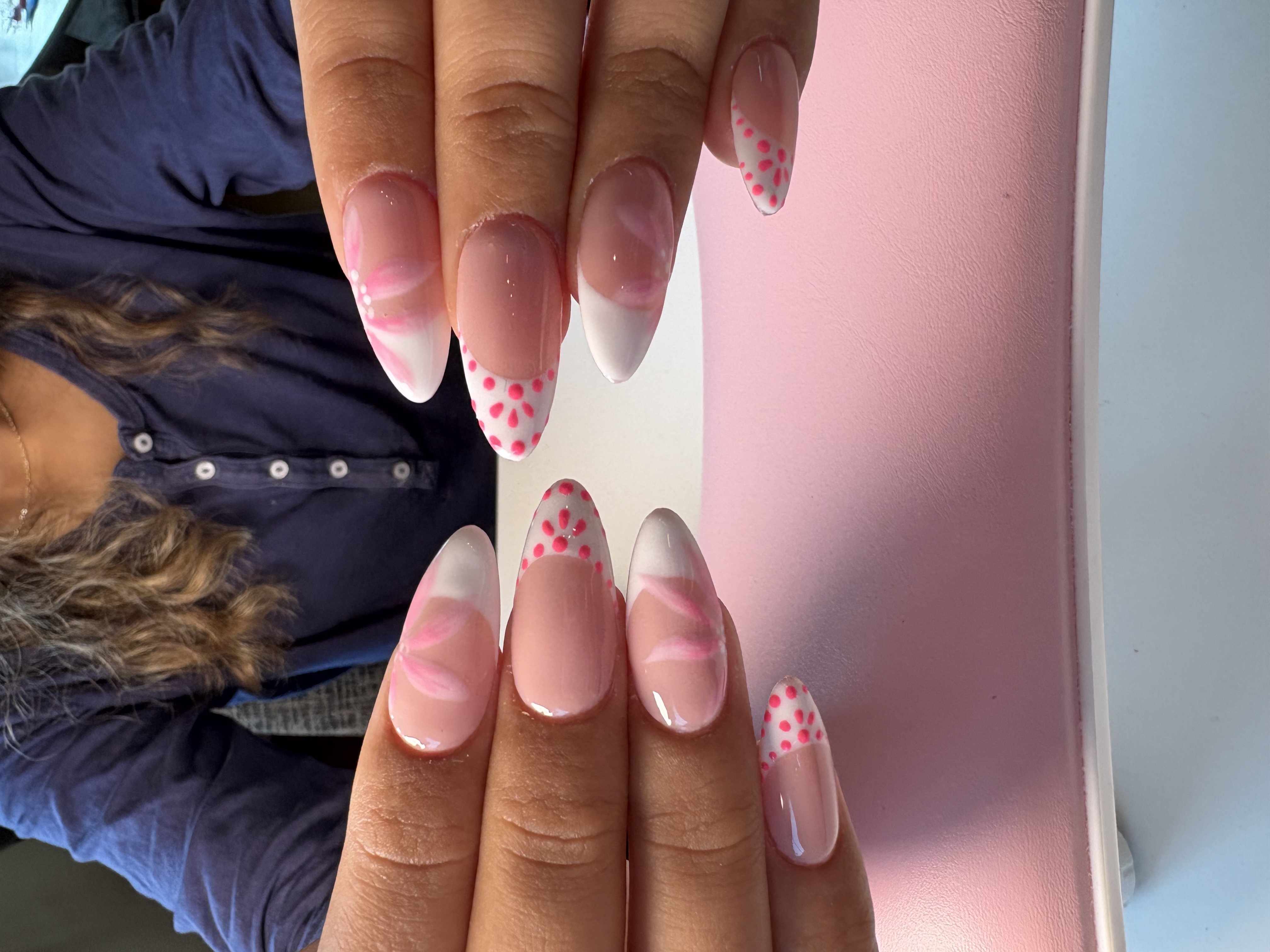 Nude almond nails with white French tips and pink hand-painted flower petals