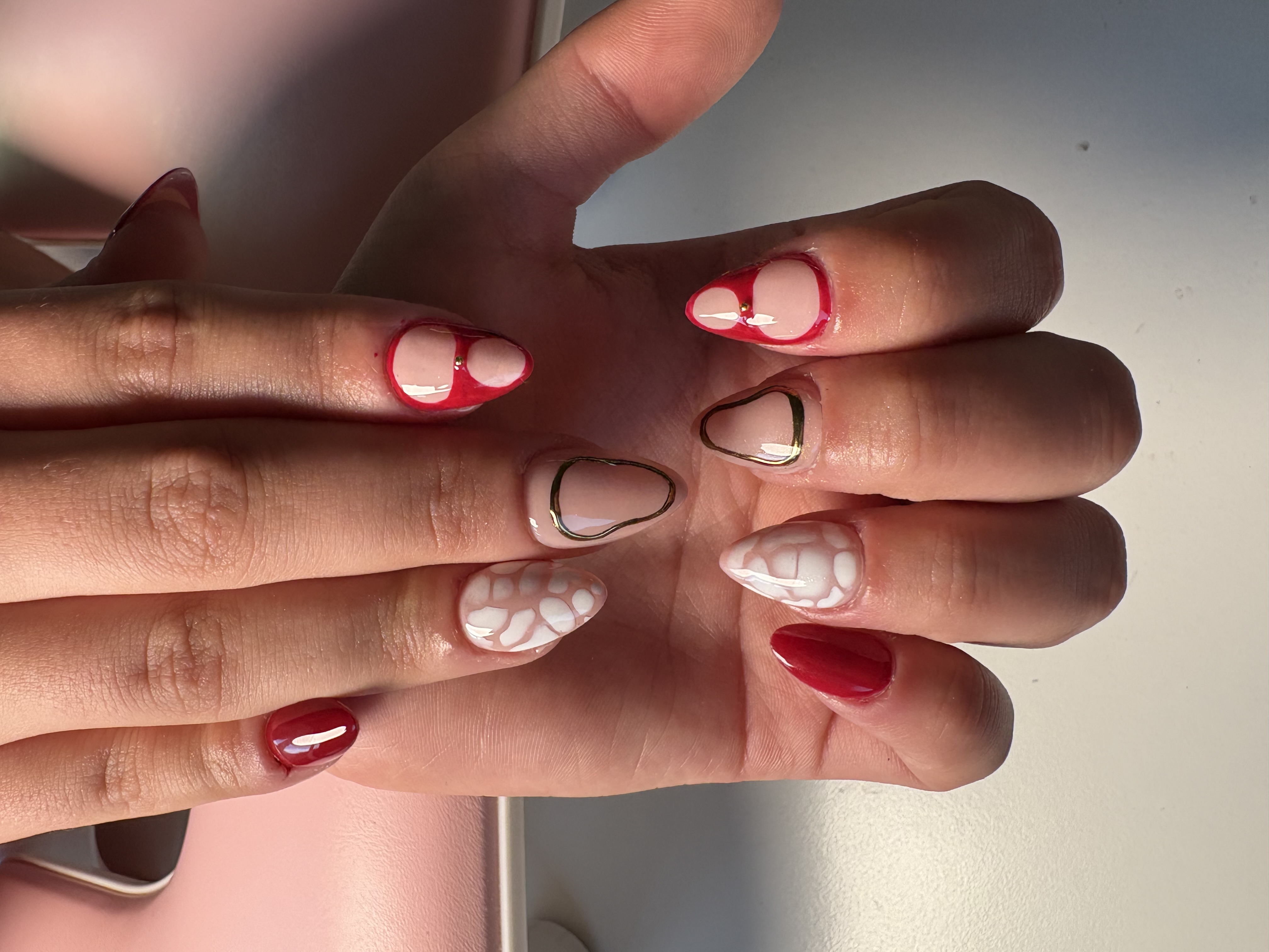 Nude square nails with white hand-painted floral vine designs and rhinestones
