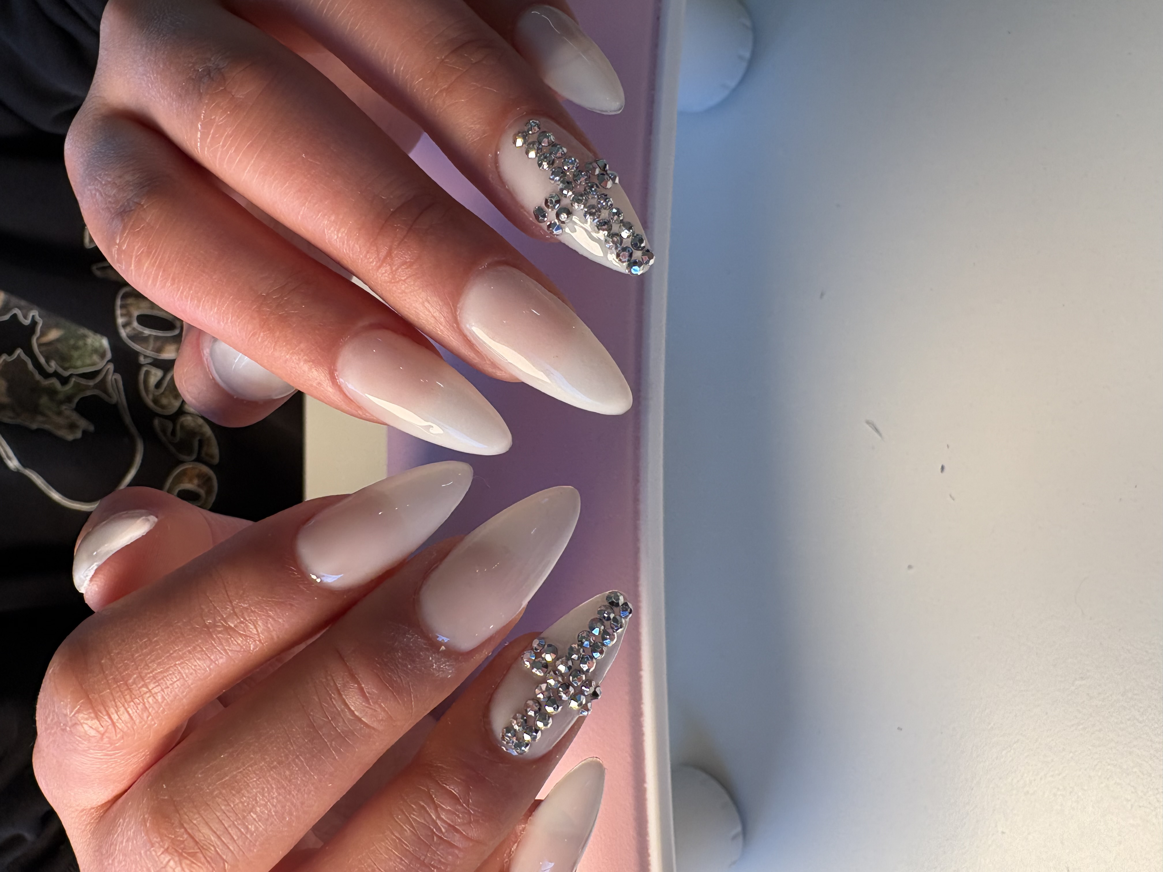 Nude ombre almond nails with a sparkling silver rhinestone stripe accent