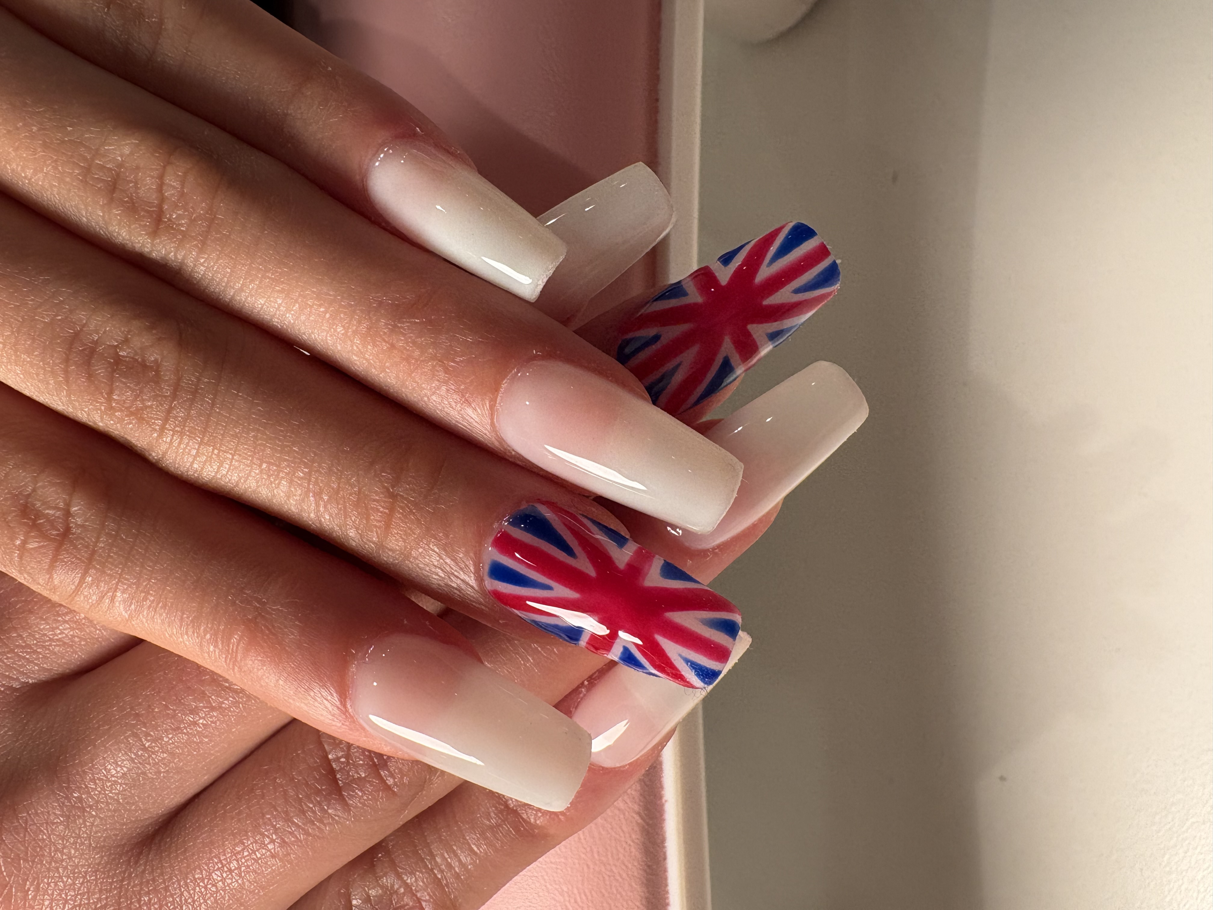 White ombre coffin nails featuring hand-painted Union Jack flag accent nails