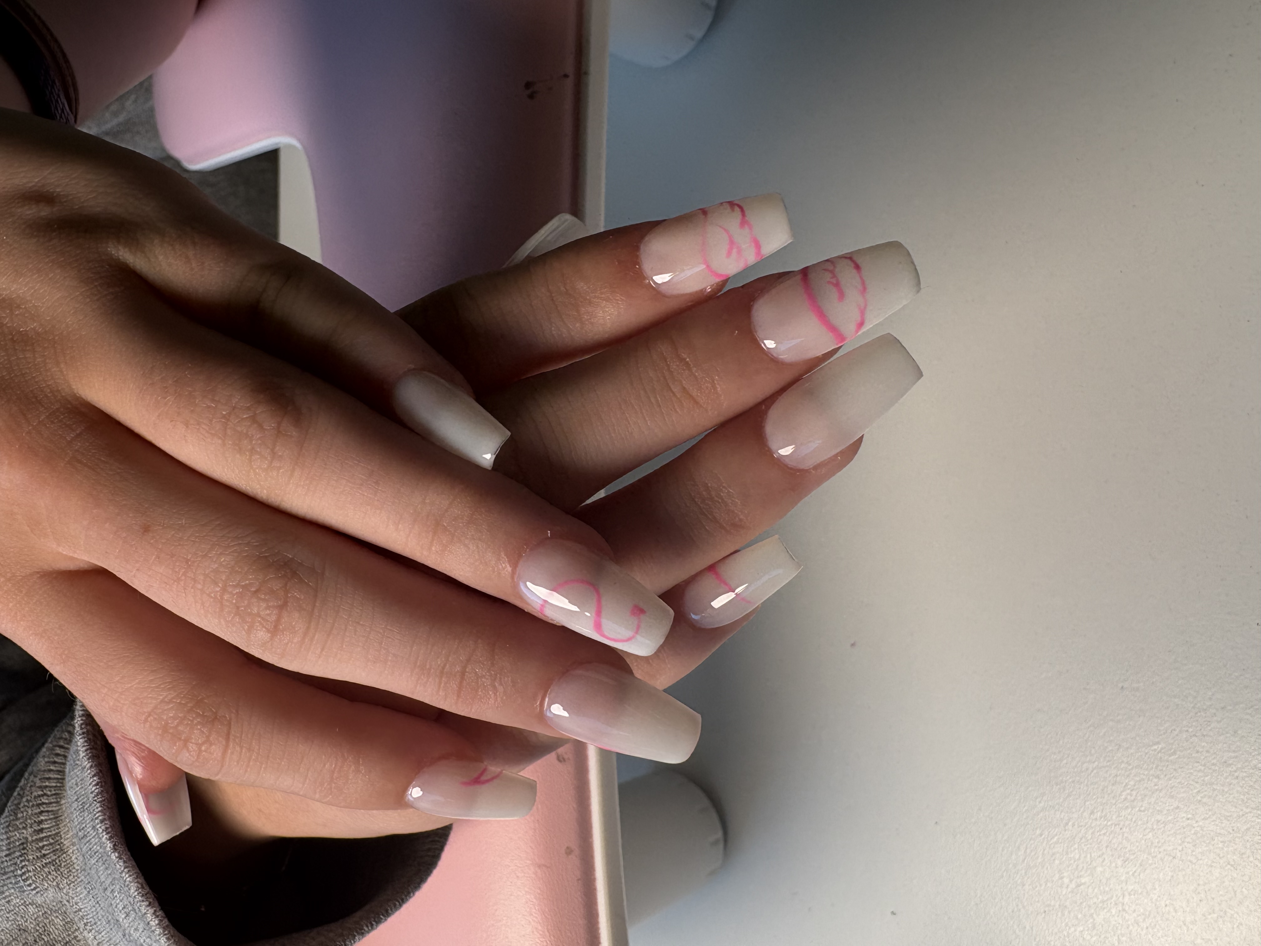 Nude square nails with delicate hand-painted pink heart and swirl line art