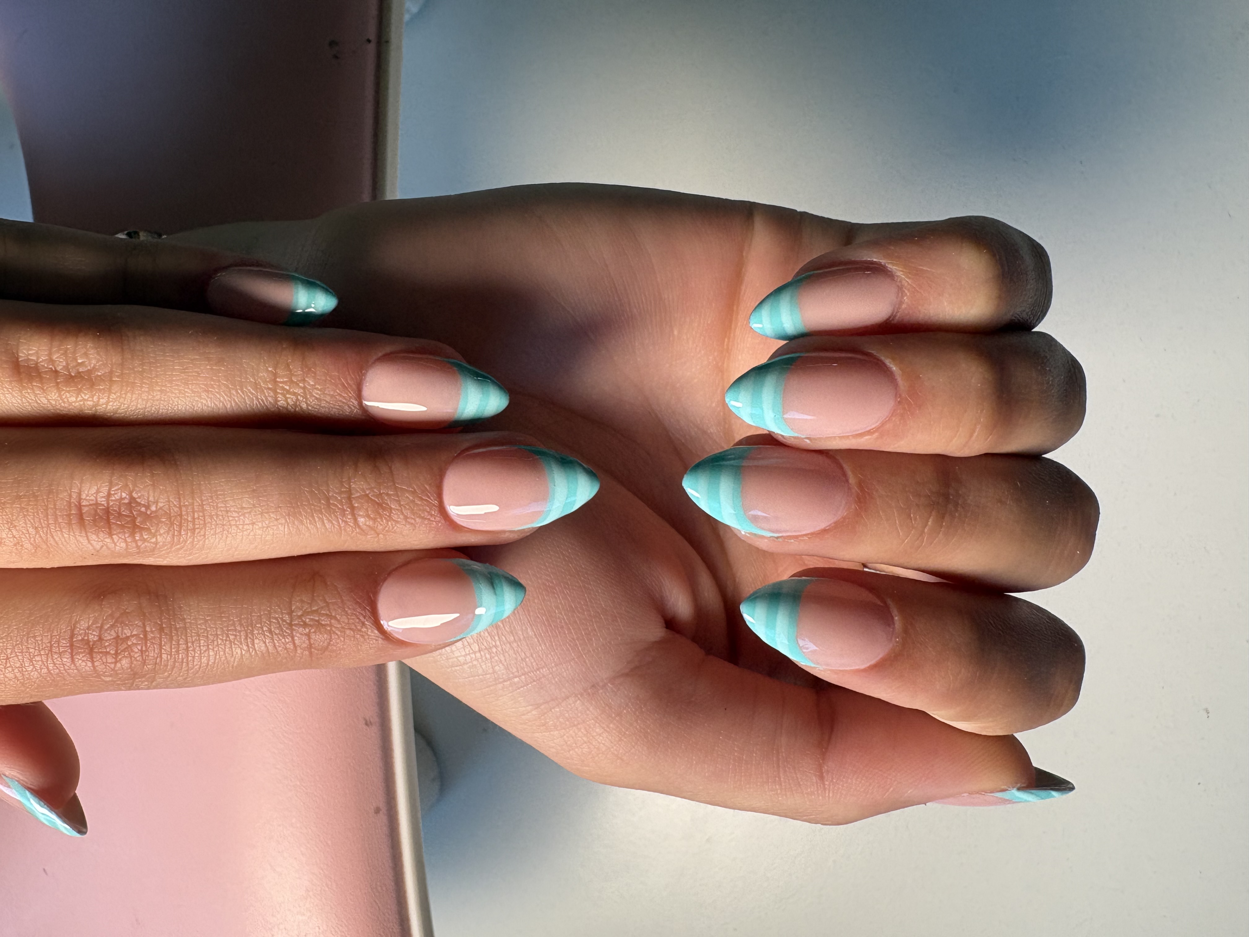 Nude almond nails with thin double-line mint green French tip outlines