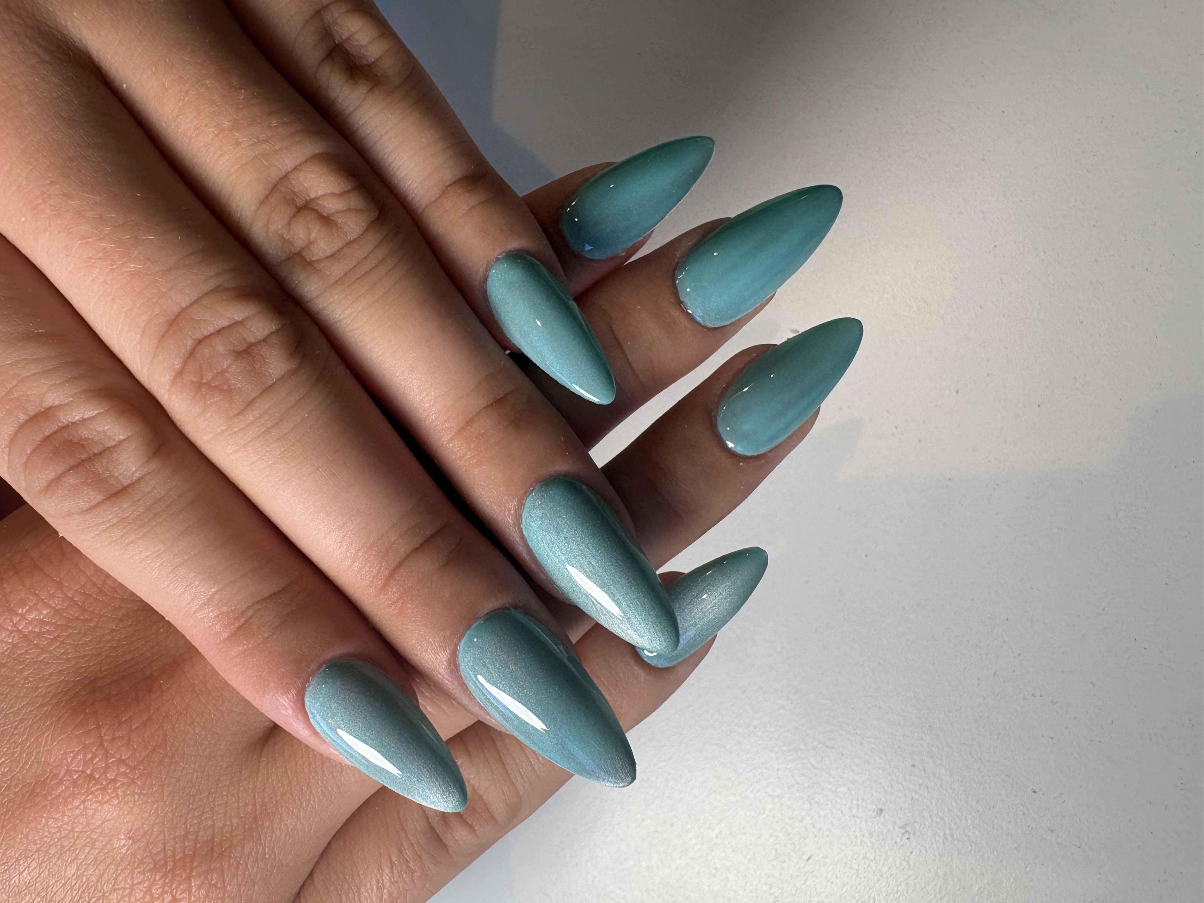 Solid glossy sage-teal almond nails