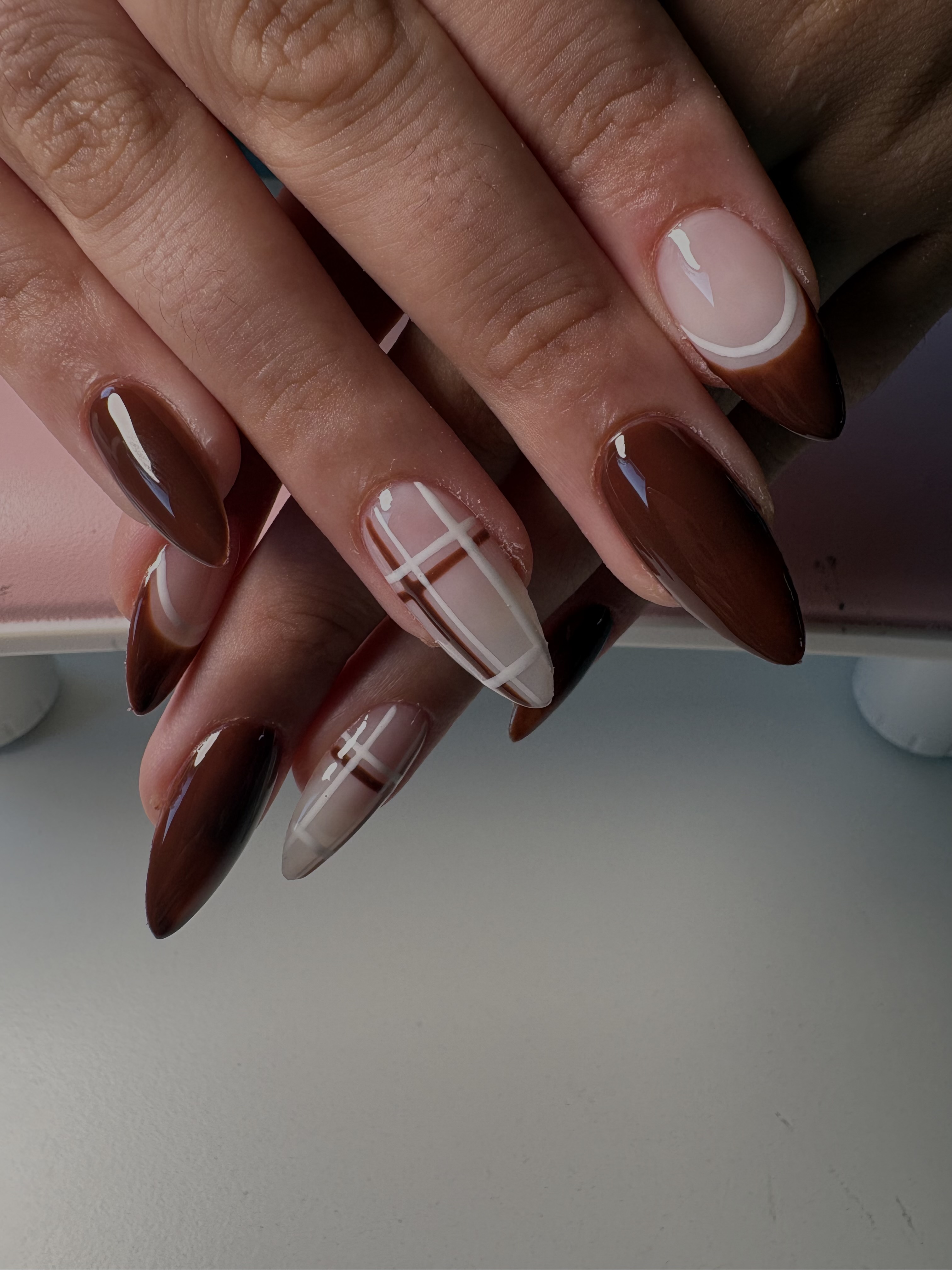 Brown ombre almond nails with a white windowpane grid linework accent nail