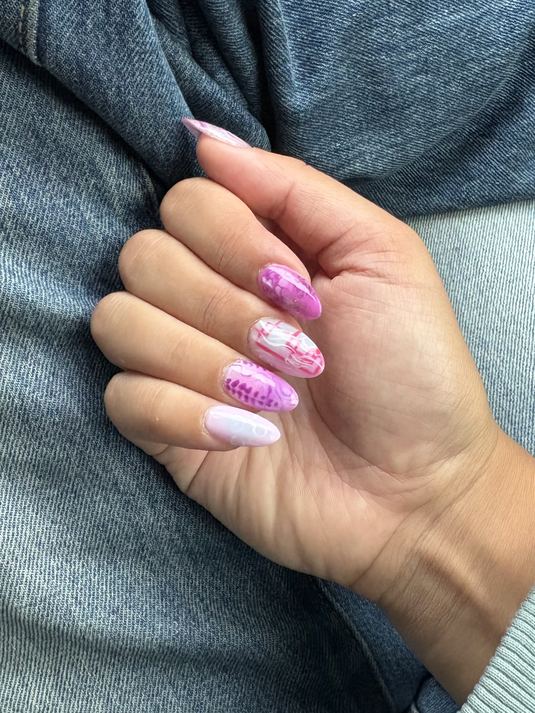 Pink and purple stiletto nails with intricate marbled swirl and grid line detailing